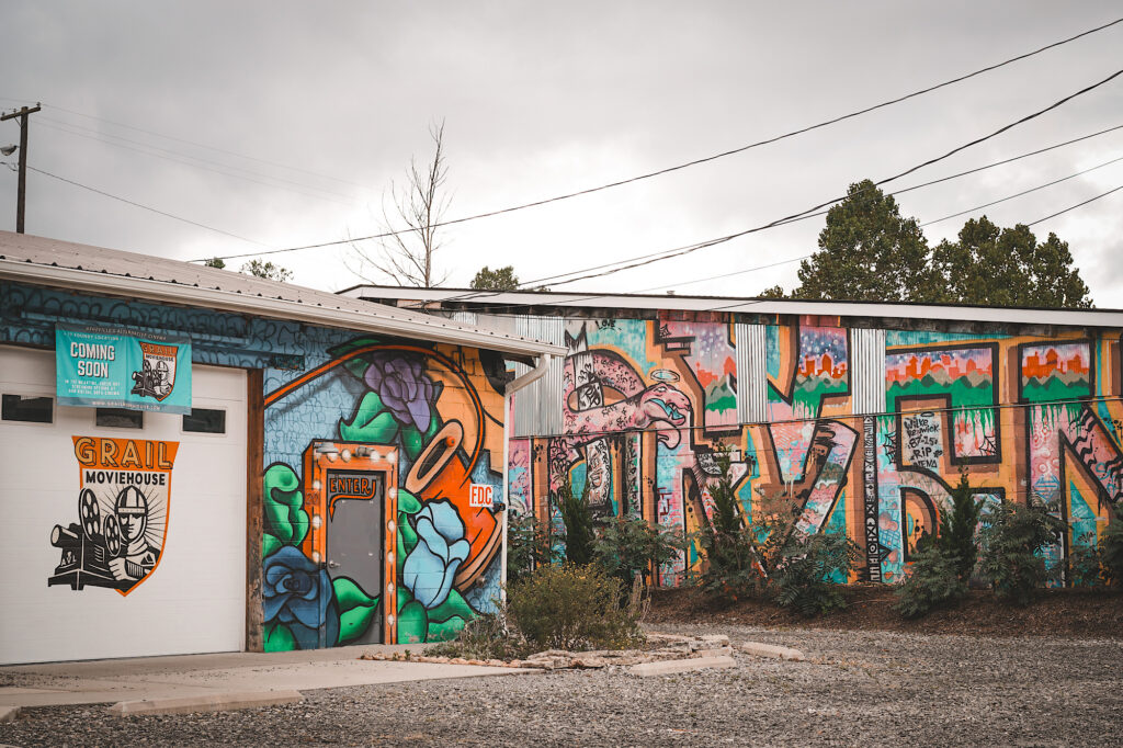 Buildings with multi-colored graffiti and murals painted on them